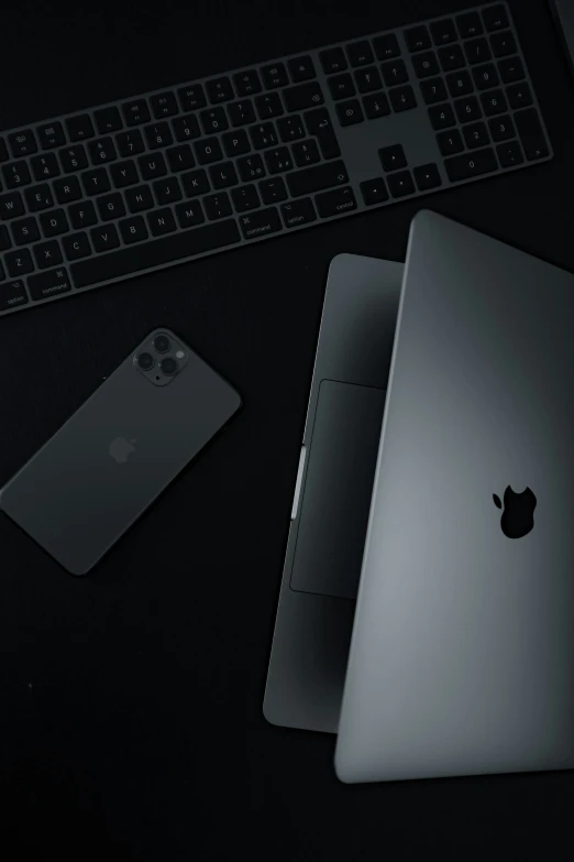 a laptop and apple keyboard on a table