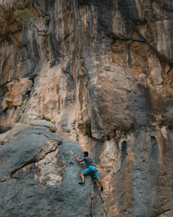 a man with skis on a rocky cliff face