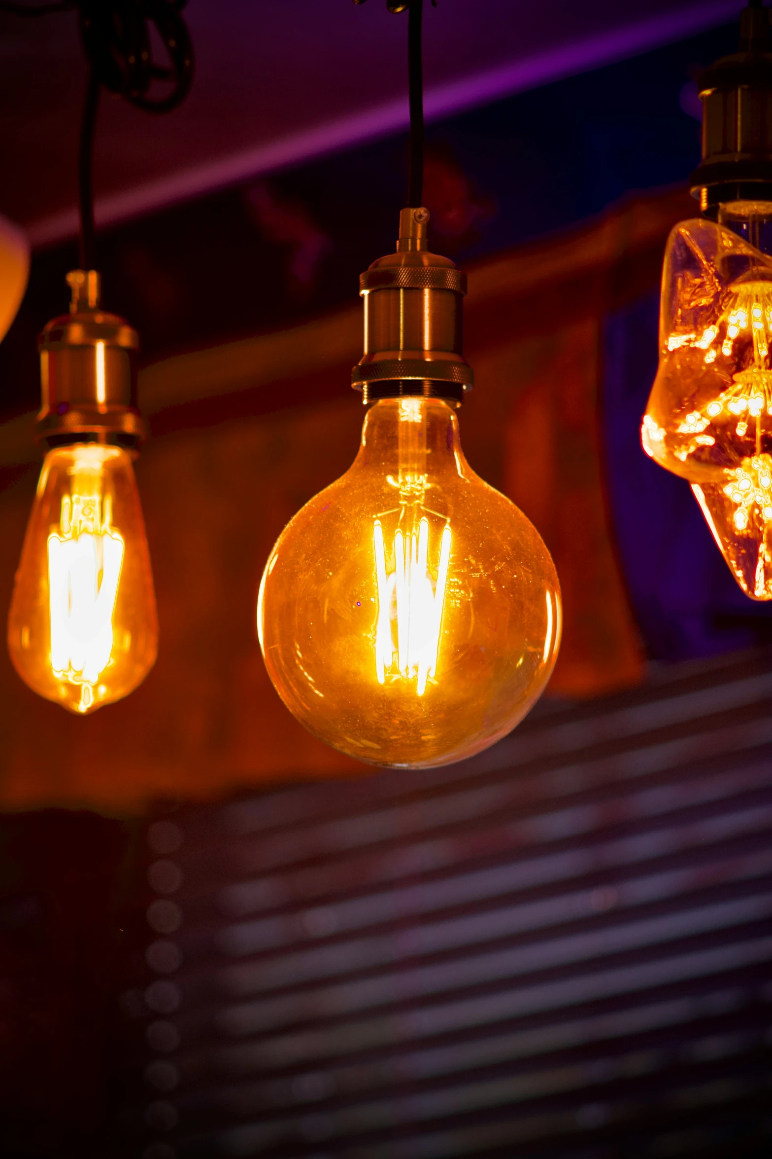 three light bulbs hung in an airy room