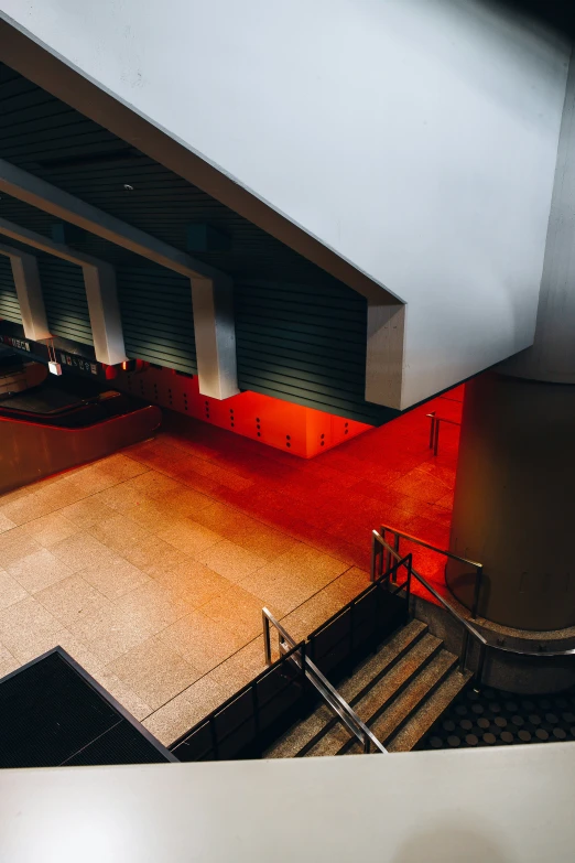 an overhead view of some staircases with a red carpet on the floor