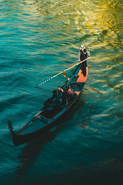 two people sitting in a small boat on the water