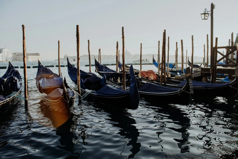 an image of several gondolas on the water