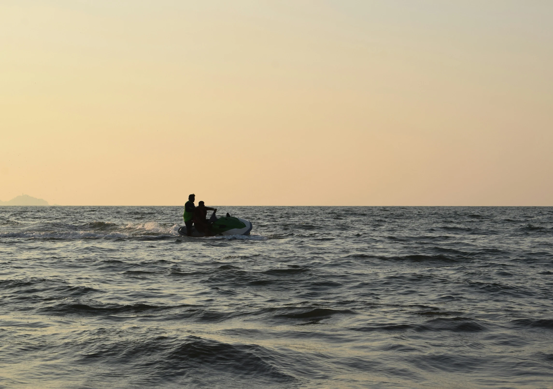 a boat is out on the ocean with two people in it