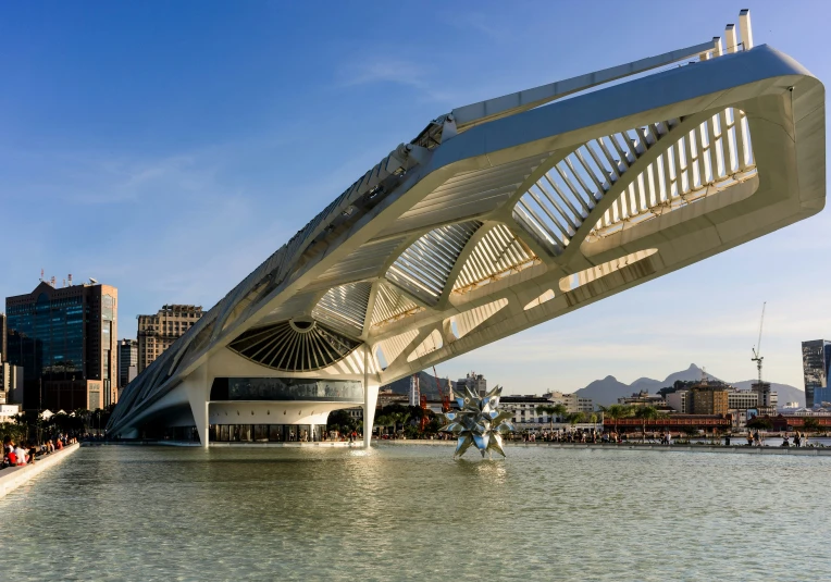 an architectural bridge over water near a city