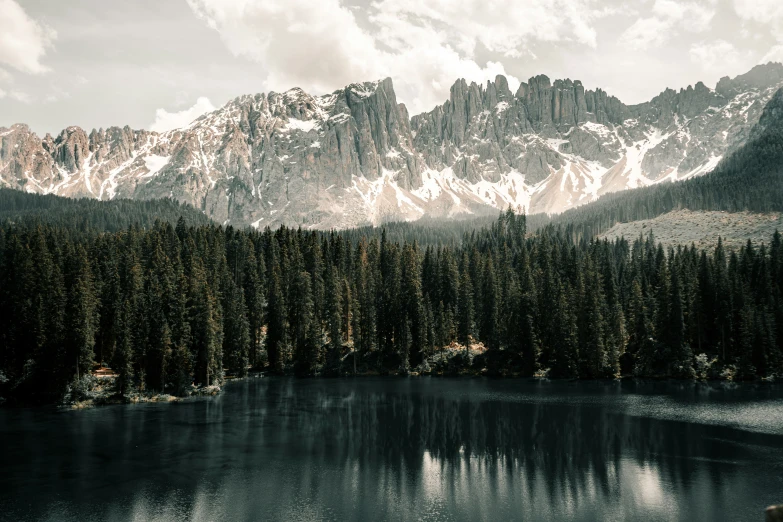 some very tall mountains by some pretty water