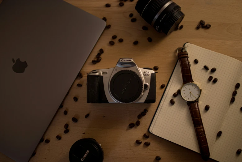 an apple computer, watch, watchband and coffee beans