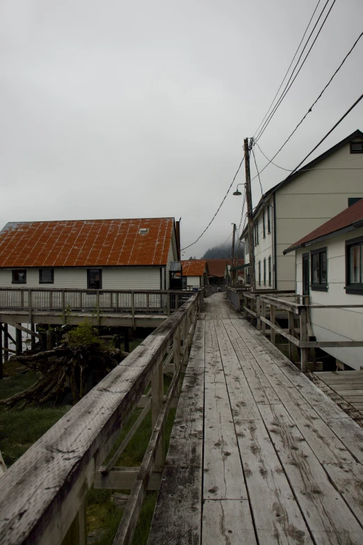 a wooden path and the house next to it