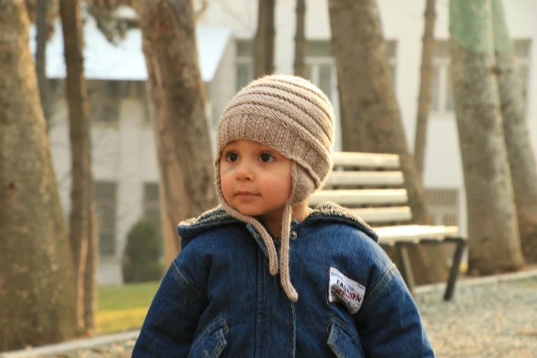 a young child wearing a hat is walking