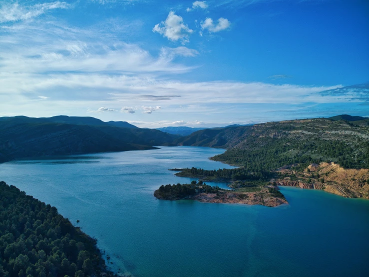 an aerial view of a lake surrounded by hills