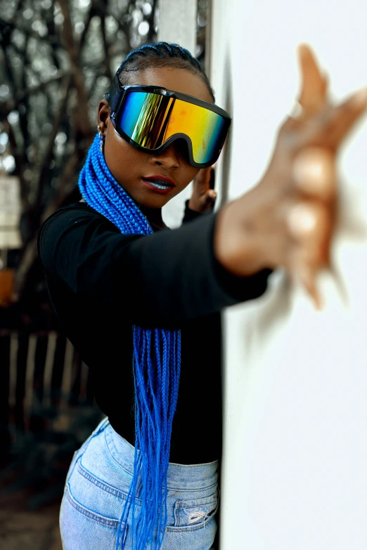 a woman is putting on sunglasses for the camera