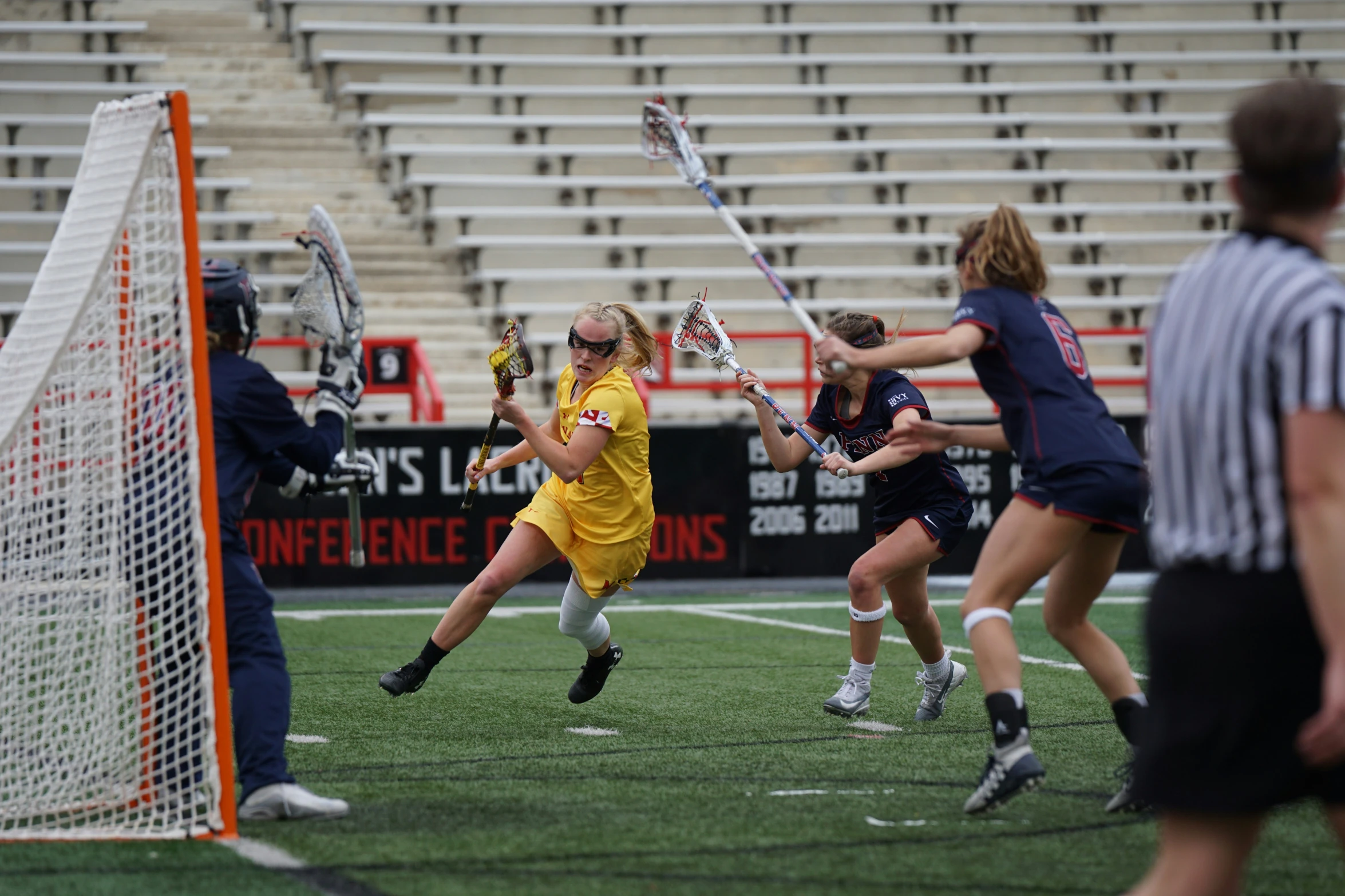 many people playing a game of lacrosse on the field