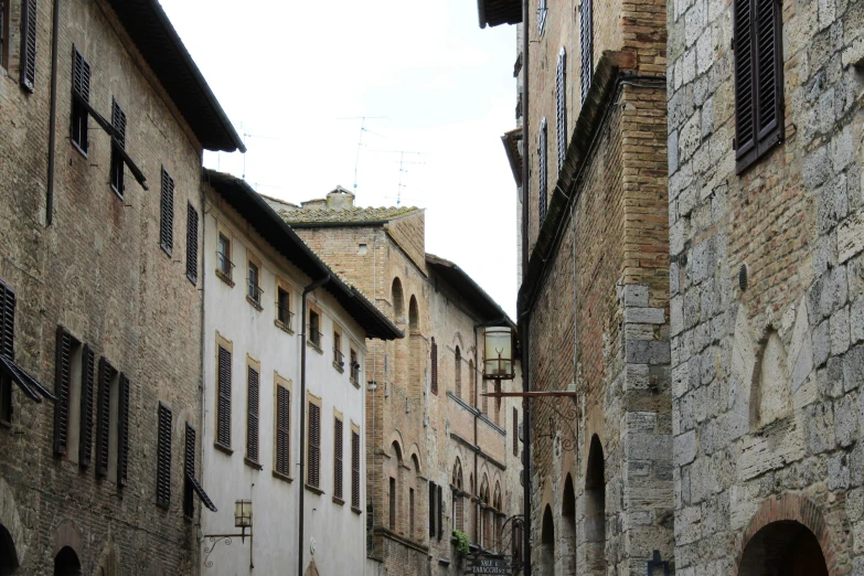 this is an image of old buildings in an alleyway