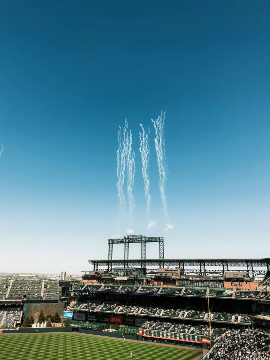 several fireworks are lit above a baseball field