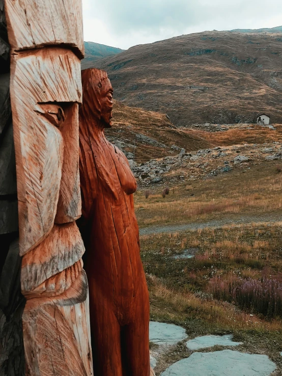 a carving of a man next to a pile of rocks