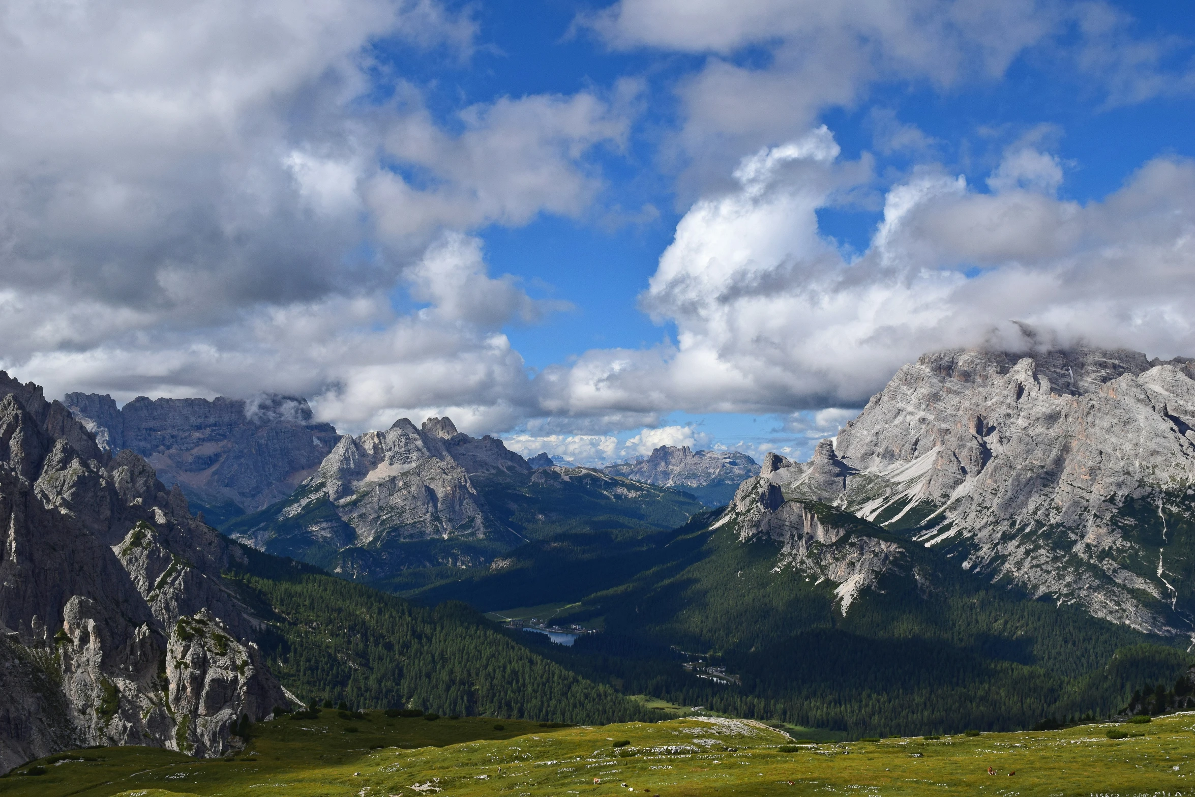 a landscape that is full of green hills and very high mountains