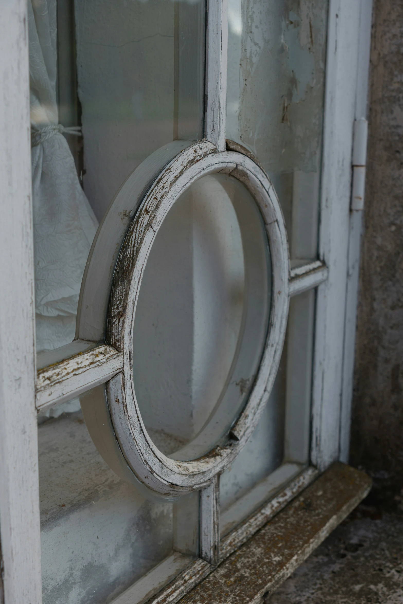 this door has a small window and is holding the handle of the clock