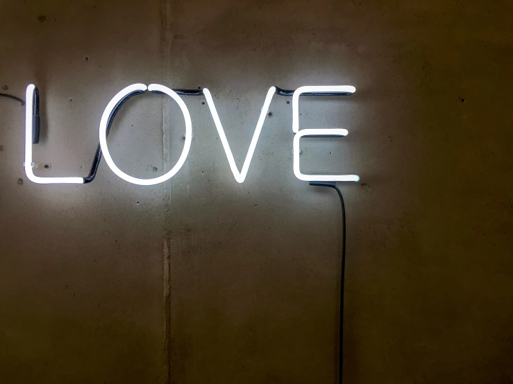 a close up of neon sign in the dark