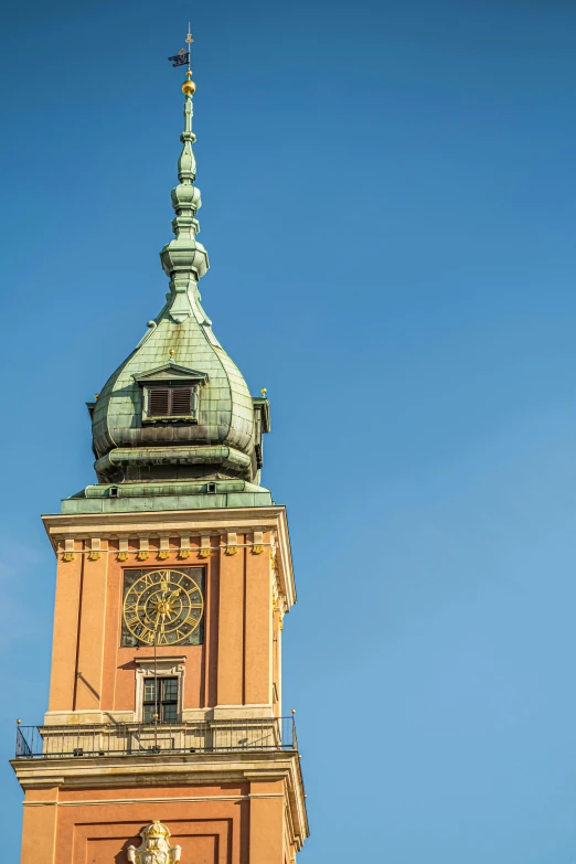 the top of the large clock tower against a blue sky