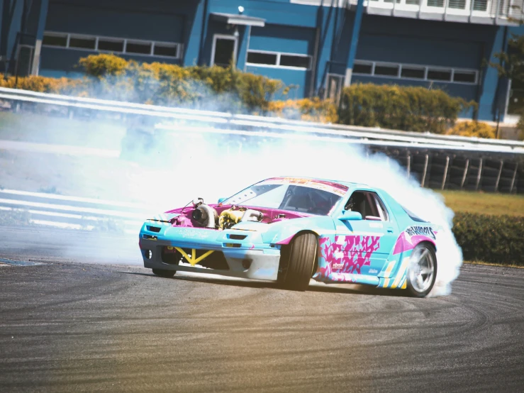 a car driving down a track with a lot of smoke coming out of it