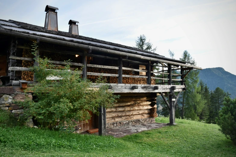 a log cabin with some chimneys and a roof