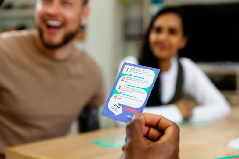 a woman holding up an electronic device with stickers on it