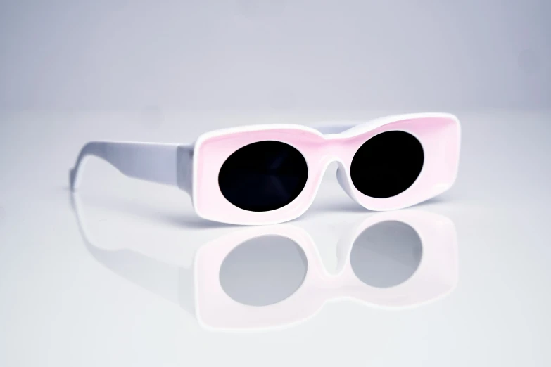 pink sunglasses with round glasses on the top of them