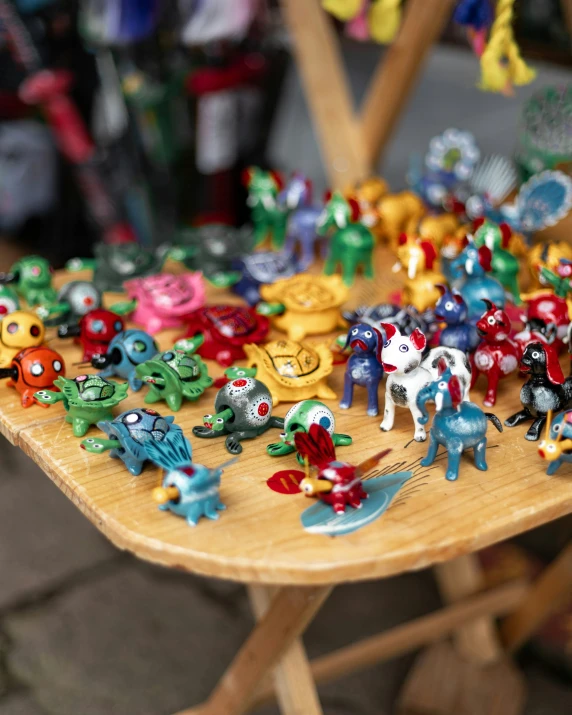 many colorful figurines on a wooden table