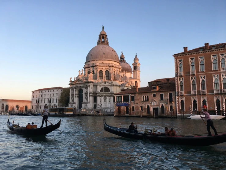 gondola boats in front of the cathedral on a quiet canal