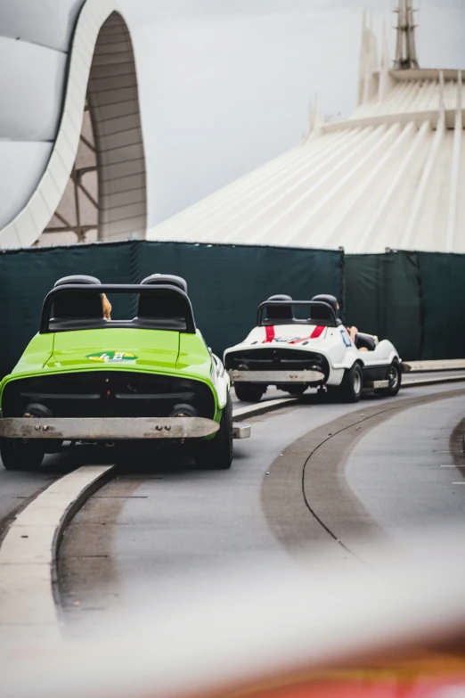 three racing cars that are on a track