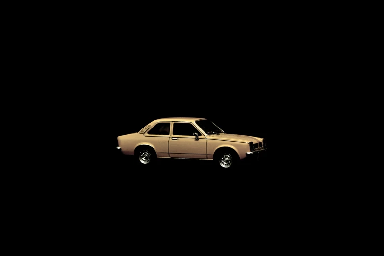 a brown car sitting on top of a dark background