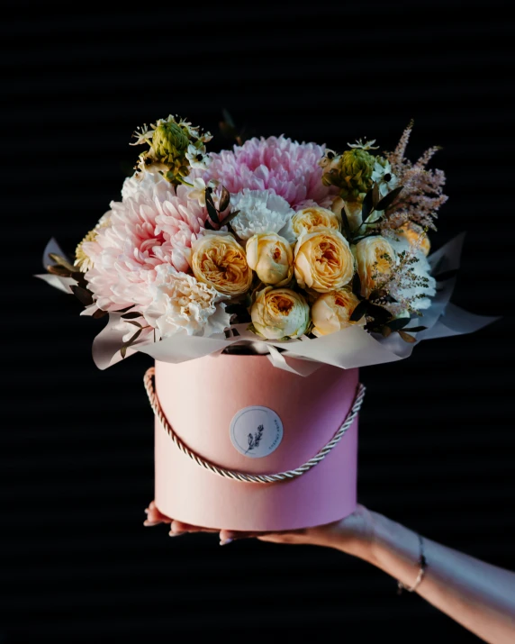 a pink vase filled with lots of pretty flowers