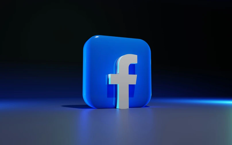 a blue and white facebook symbol is featured with a black background