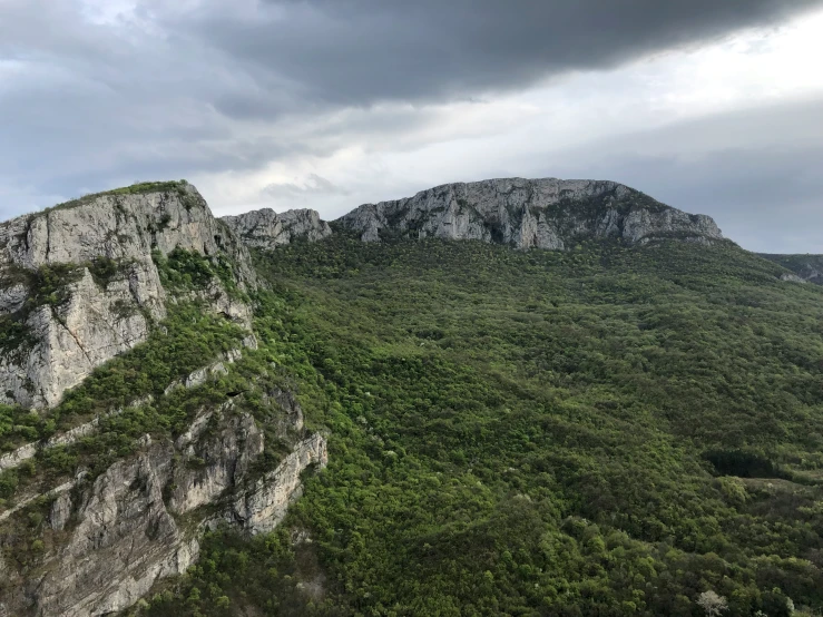 some very large rocks and trees and a mountain