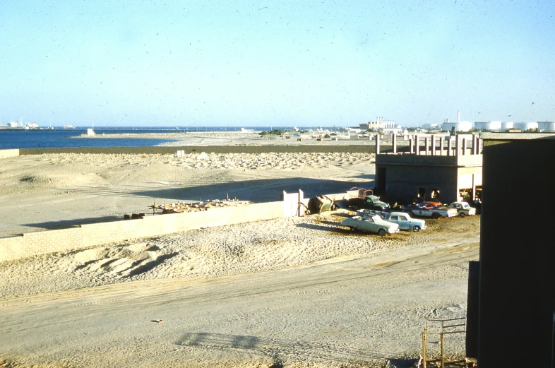 two vehicles parked in a lot near the beach