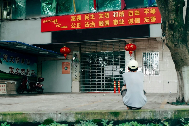 a person walking down the sidewalk near a large chinese building