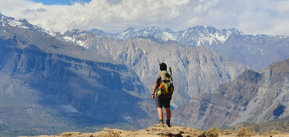 a man is looking at the beautiful mountains