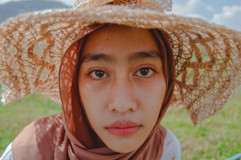 a woman with a large hat on her head