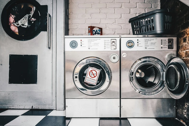 washing machine next to stacking dishes in kitchen area