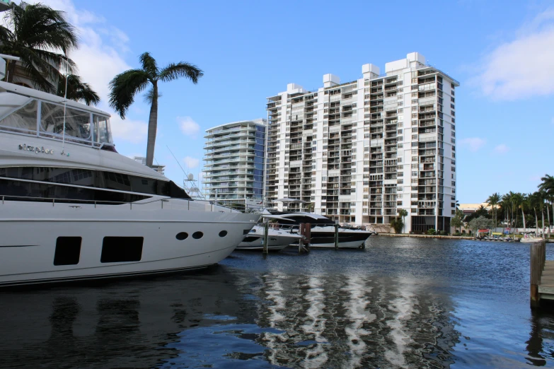 two boats docked at a dock near several buildings