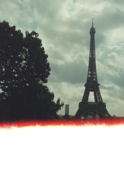 a picture taken of the eiffel tower against a cloudy sky