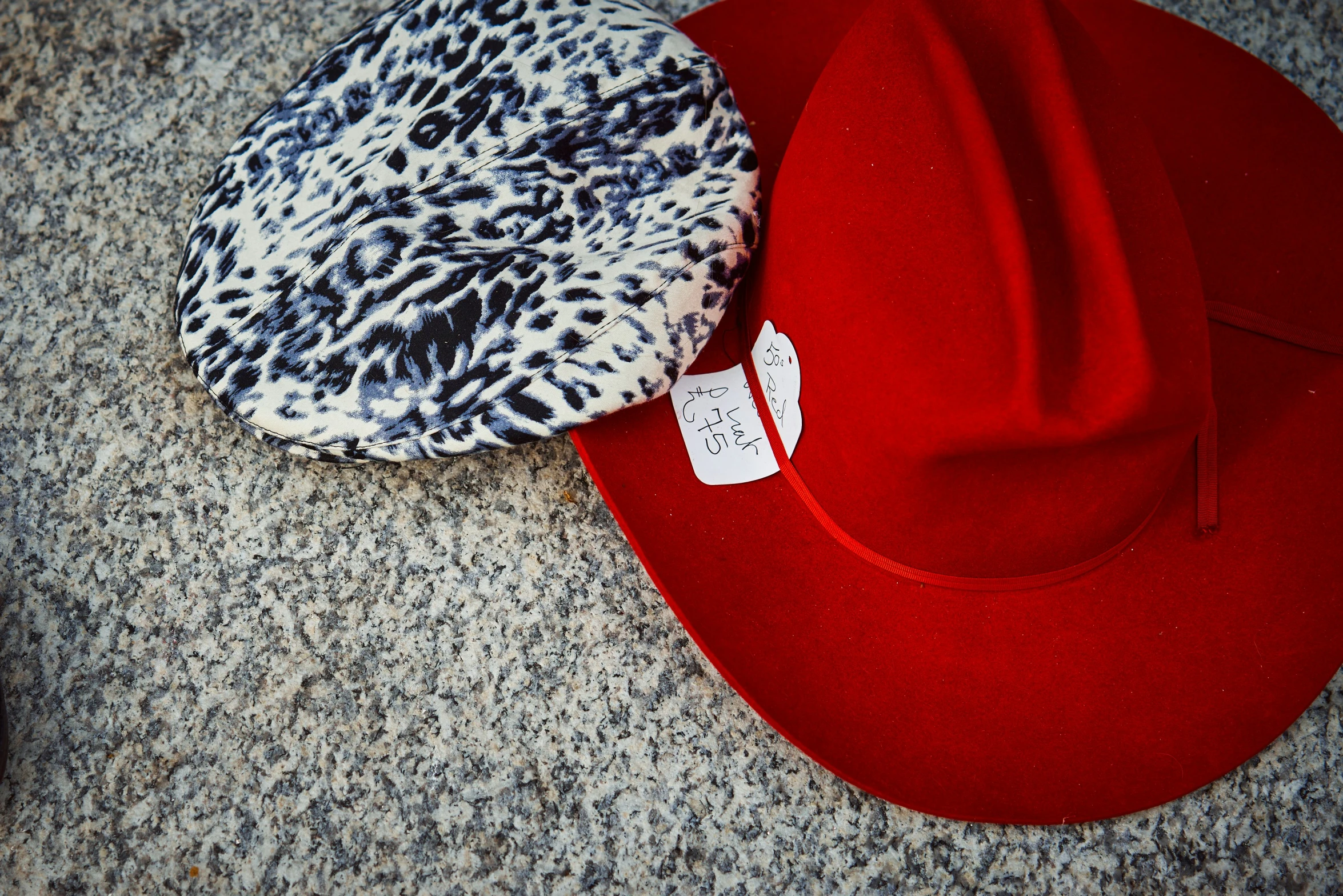 two hats, one black and white, sitting on a surface