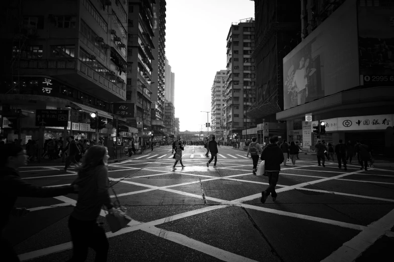 a street scene with pedestrians and buildings on the side