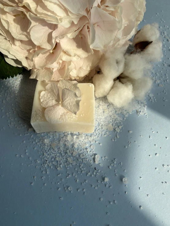 a single piece of soap on a blue surface with water drops