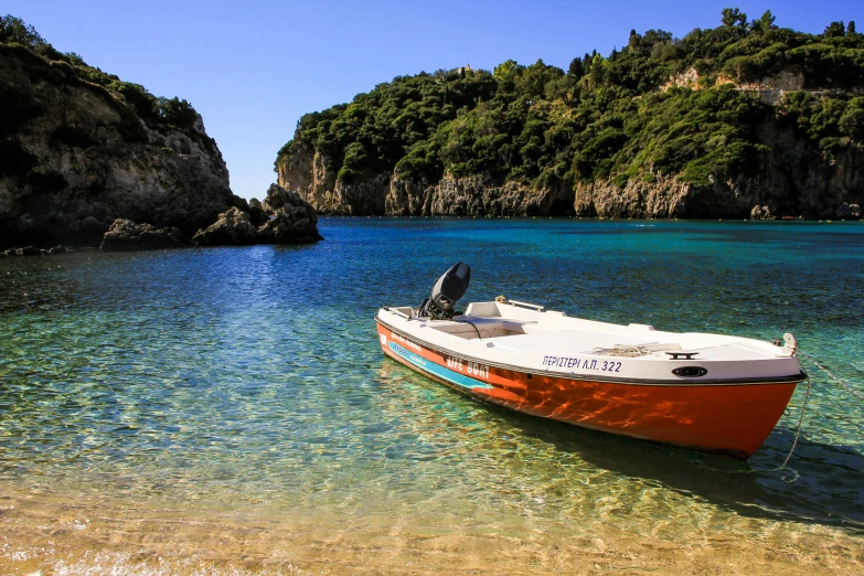 the small boat is on the clear sea water