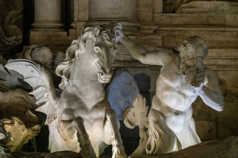 some white sculptures and statues inside of a building