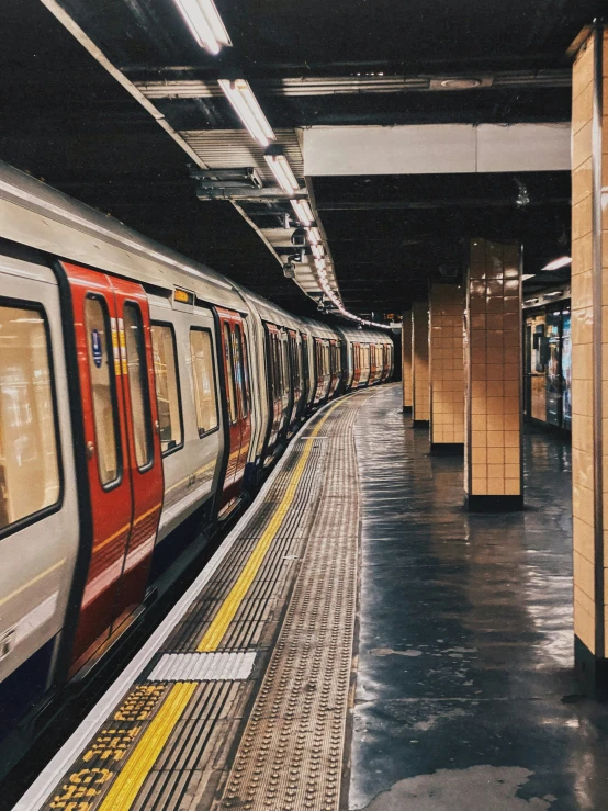 a subway train sitting on a track in a subway station