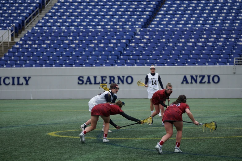 a group of people playing a game of field hockey