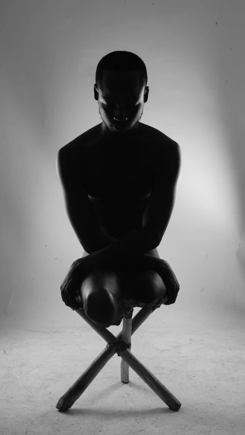 a black man seated on top of a chair