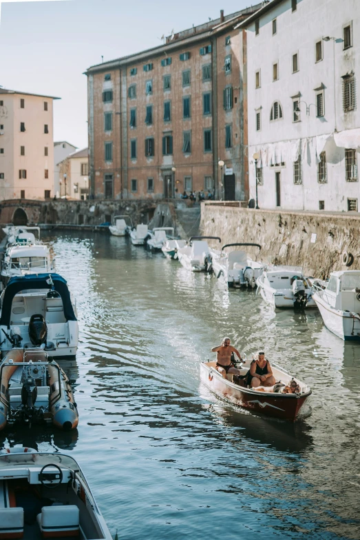 boats are parked along the side of the river