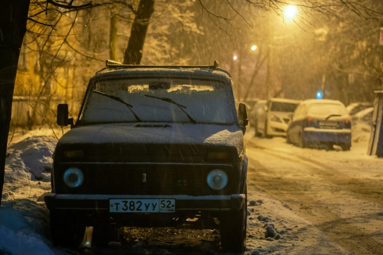 an old van is parked on the street under the snow